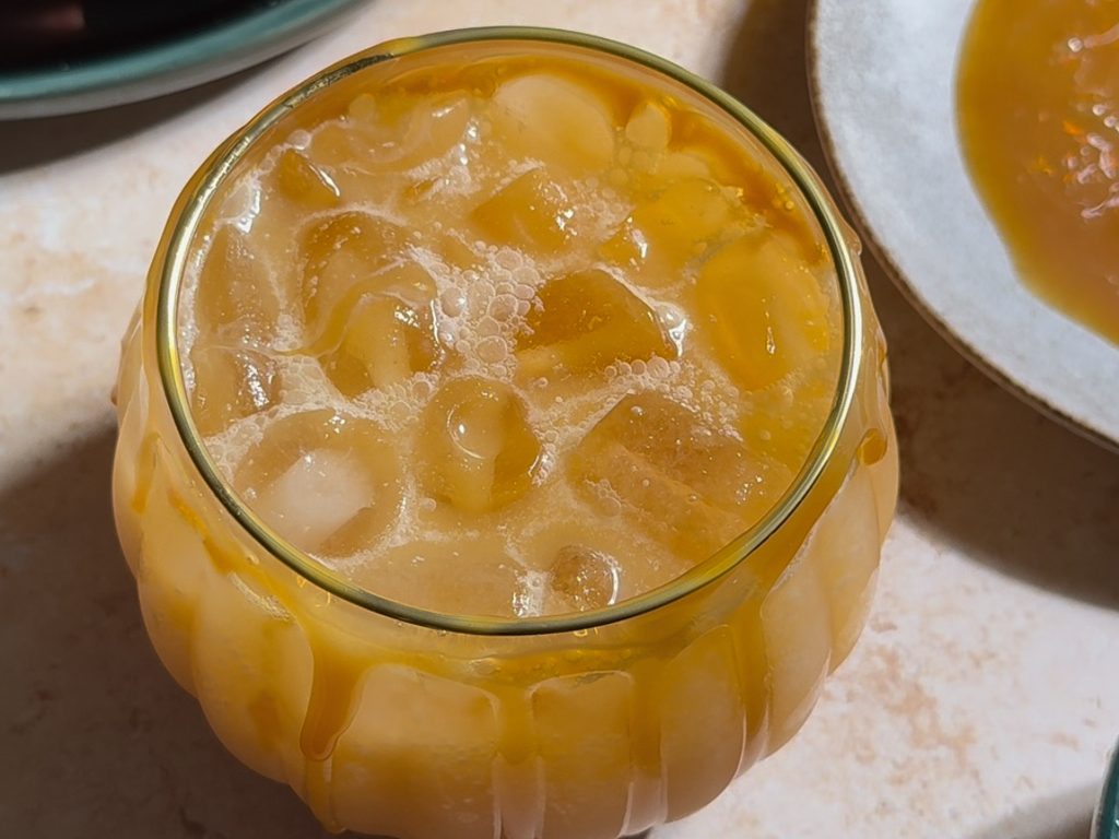 Caramel Apple Margarita Mockatail being poured into pumpkin glass