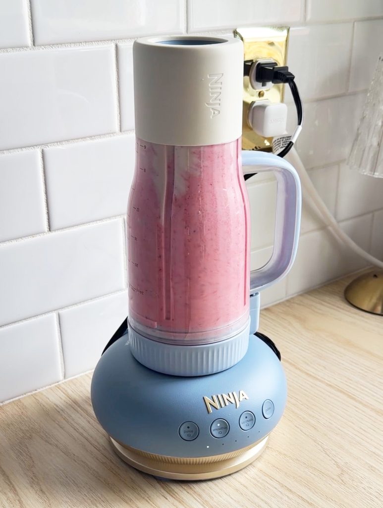 ninja blendboss tumbler blender with strawberry smoothie on a kitchen counter