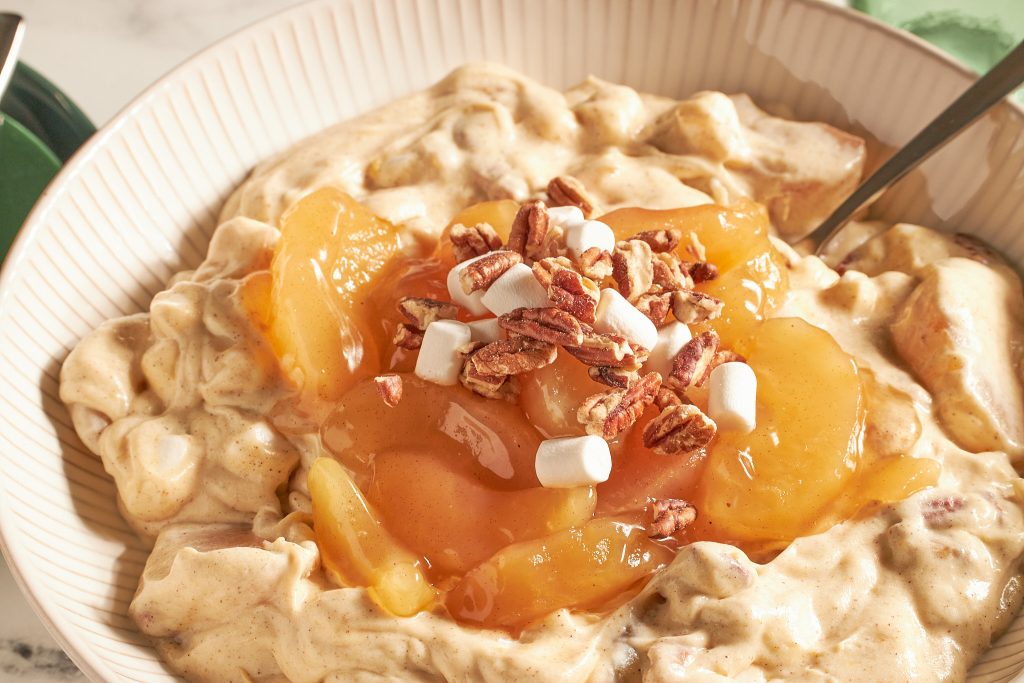 close up apple pie fluff salad in a white bowl